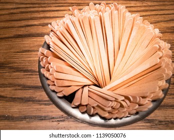 Wooden Stir Sticks Is On A Brown Wooden Table. Stick For Coffee. 