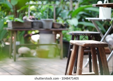 Wooden Stool In Green Garden