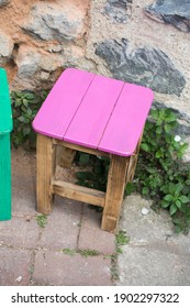 A Wooden Stool With A Pink-painted Top, Seat Furniture For A Country House