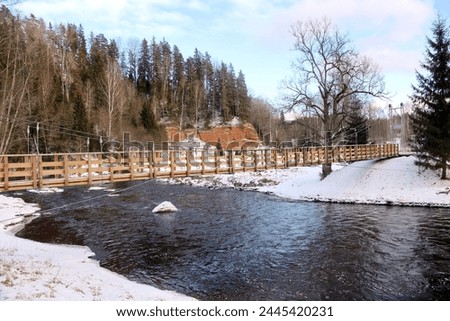 a wooden structure metal wire bridge was built over the river
