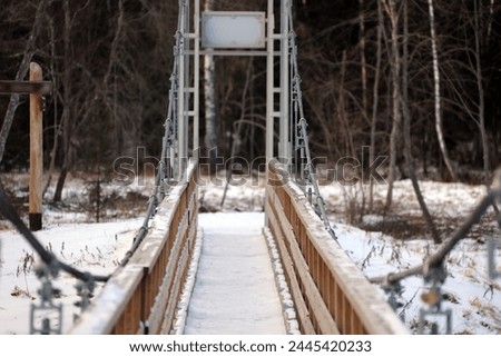 a wooden structure metal wire bridge was built over the river