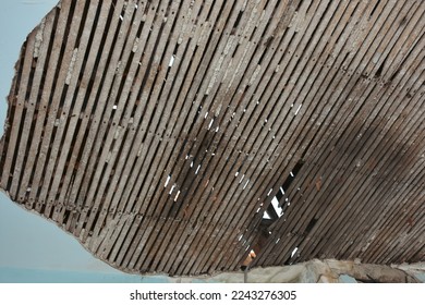 Wooden structures left behind a plastered wall in an abandoned house. Can be used for roof repair, earthquake, disease, famine and poverty