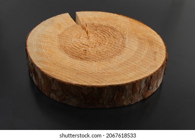 Wooden stump, cross section, cut wood tree trunk slice, circular piece of pine on black background
