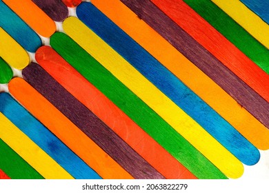 Wooden Sucker Stick Background Dyed With Food Colouring Highlighting Textures And Patterns 

