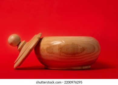 Wooden Sugar Bowl On A Red Background.