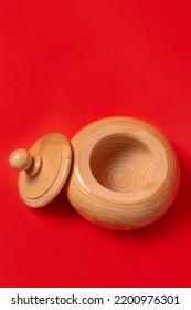 Wooden Sugar Bowl On A Red Background.