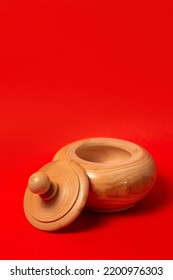 Wooden Sugar Bowl On A Red Background.