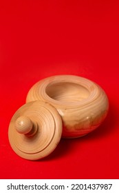 Wooden Sugar Bowl On A Red Background.