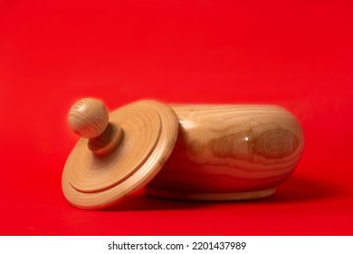 Wooden Sugar Bowl On A Red Background.