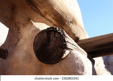 A Wooden Support Beam Sticking Out Of The Adobe Buildings Of The Mission San José De Tumacácori.