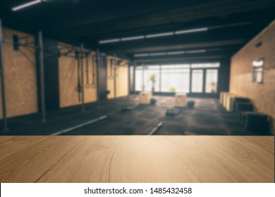 Wooden Surface With Unfocused Crossfit Room In The Background, Gym Table.