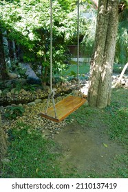 Wooden Swing Set In Green Natural Garden Park