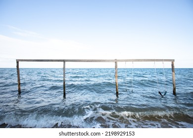 Wooden Swing Set On The Ocean In Hopkins Belize