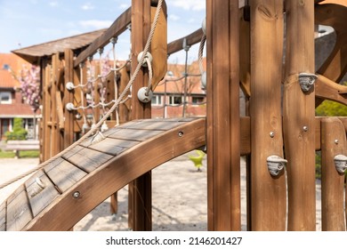 Wooden Swing Set With Rope And Climbing Equipment On A Childrens Playground In Eindhoven, The Netherlands. Friendly Rounded Construction Shapes For Kids