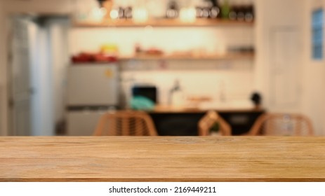 Wooden table against blurred modern kitchen in background. Copy space for display or montage your products - Shutterstock ID 2169449211