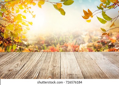 Wooden Table With Autumn Leaves In Sunny Day Background