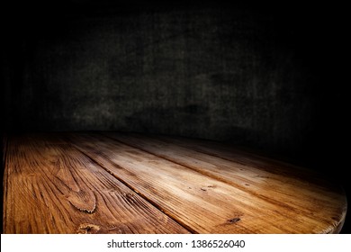 Wooden table background of free space for your decoration. Black shadow and wall of free space for your text. 