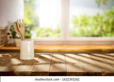 Wooden Table Background In Kitchen Interior.Dark Shadows Of Sun Light And Window Sill With Green Plants.Copy Space For Your Product And Spring Time. 