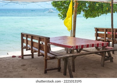 A Wooden Table And Bench With A Linoleum Covered Top Right By The Beachfront. At Libaong Beach, Panglao, Bohol, Philippines.