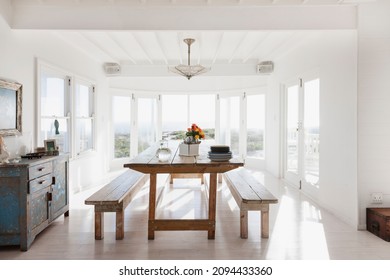 Wooden Table And Benches In Sunny Dining Room