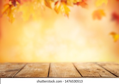  Wooden table and blurred Autumn background. Autumn concept with red-yellow leaves background. - Shutterstock ID 1476530513