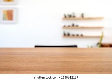 Wooden table with blurred white wall background  - Shutterstock ID 1239612169
