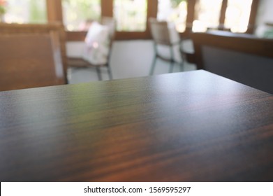 Wooden Table In The Cafe, Blurred Background, Perspective View.