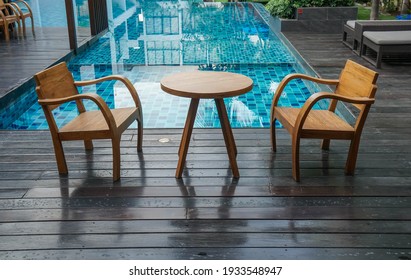 Wooden Table And Chairs At The Poolside For Breakfast In Luxury Hotel