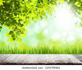 Wooden table with copy space for your product and green sunny bokeh. Outdoor template - Shutterstock ID 2192709401