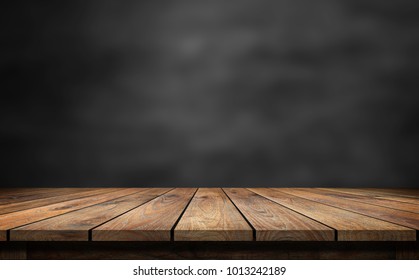 Wooden table with dark blurred background.