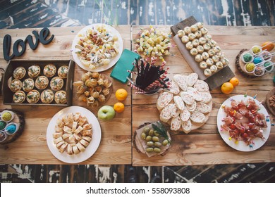 Wooden Table With Different Type Of Snacks Preparing For Party.