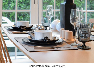 Wooden Table In Dining Room With Elegant Table Setting