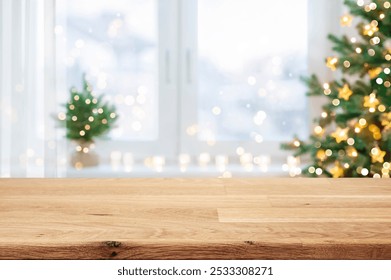 Wooden table for display products with blurred Christmas tree and window interior background - Powered by Shutterstock