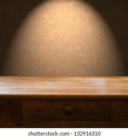 Wooden table with drawer and light backdrop - Shutterstock ID 132916310