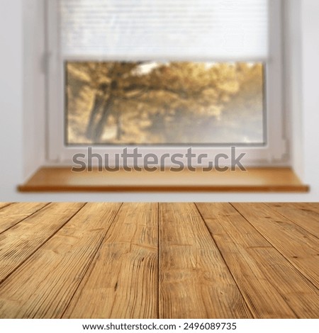 Wooden table with empty copy space for products. Window background overlooking blurred autumn garden. Image can be used for display or montage your products.