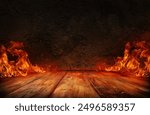 wooden table with Fire burning at the edge of the table, fire particles, sparks, and smoke in the air, with fire flames on a dark background to display products	