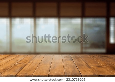Wooden table of free space and blurred background of japan interior with big window . 