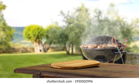 Wooden table of free space and grill in garden  - Shutterstock ID 1950502996