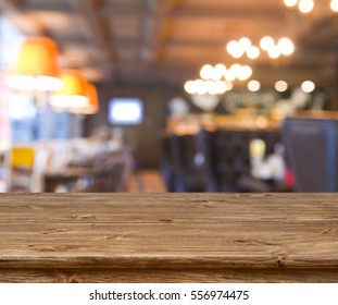 Wooden Table In Front Of Abstract Blurred Resturant Lights Background