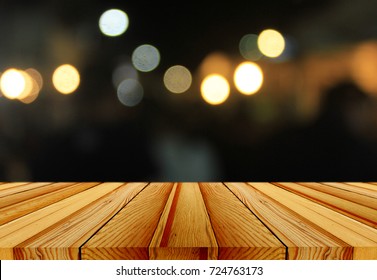 Wooden Table In Front Of Abstract Blurred Background Of Resturant Lights