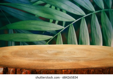 Wooden Table In Front Of Tropical Green Floral Background. For Product Display And Presentation.