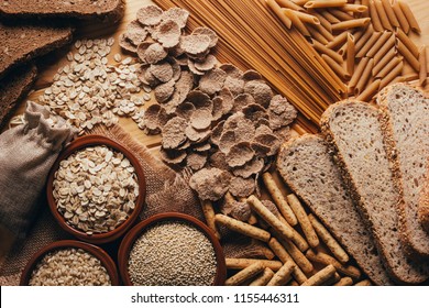 Wooden table full of fiber-rich whole foods, perfect for a balanced diet - Shutterstock ID 1155446311