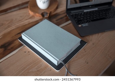 Wooden table with laptop and notepad for notes