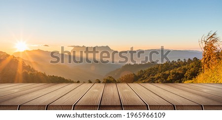 wooden table and mountain landscape in sunlight