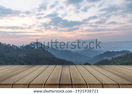 wooden table and mountains landscape in morning sky