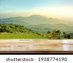 Wooden table on blur mountain morning or evening view landscape, Warm feeling in orange or brown tones.