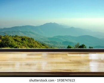 Wooden table on blur mountain morning view landscape, Cool feeling in blue tones.