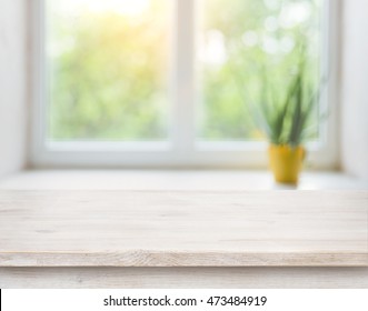 Wooden Table On Blurred Autumn Window With Plant Pot Background