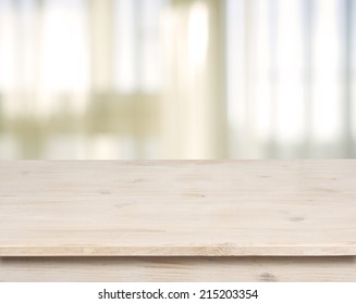 Wooden table on defocuced window with curtain background