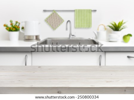 Wooden table on kitchen sink interior background